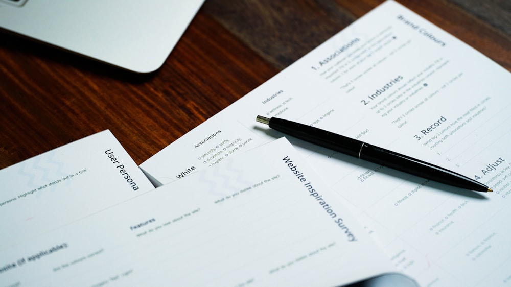 Pen and documents arranged on a wooden desk